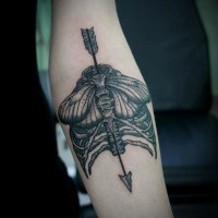 Tatuaje en el antebrazo, diseño combinado de esqueleto flecha y polilla