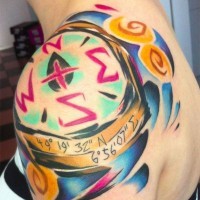 Original painted and colored compass shaped tattoo with coordinates on shoulder