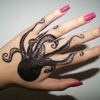 Original painted black and white little octopus tattoo on hand
