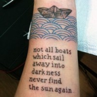 Original painted black ink paper ship with lettering tattoo on wrist