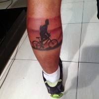 Original painted colored bike rider tattoo on leg