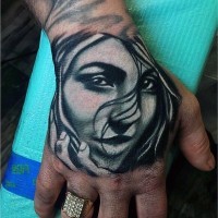 Tatuaje en la mano,  cara de mujer simpática