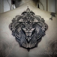 Ornamental style black ink back tattoo of mystical face