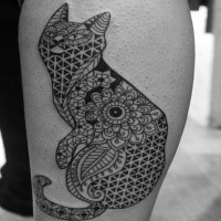 Ornamental style black ink leg tattoo of cat stylized with various ornaments