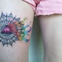 Ornamental style colored thigh tattoo of big flower with triangle