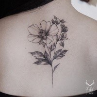 Outline style black ink upper back tattoo of flower by Zihwa