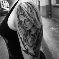 Painted by Inez Janiak black ink upper arm tattoo of woman with pigeon