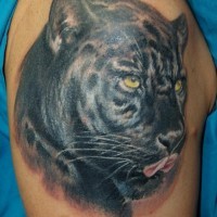 Panther face tattoo on shoulder