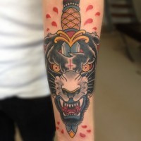 Panther head with a dagger tattoo on arm