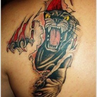 Tatuaje en el omóplato de una pantera bajo el corte de la piel.