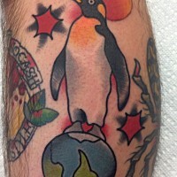 Penguin tattoo standing on planet