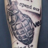 Photoshop style black and white military grenade tattoo on forearm combined with lettering