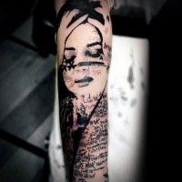 Photoshop style black ink arm tattoo of lettering and woman face