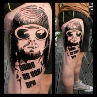 Photoshop style black ink thigh tattoo of smoking man in sun glasses with lettering