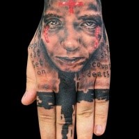 Photoshop style colored hand tattoo of woman face with red cross and lettering