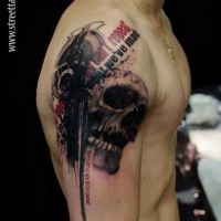 Photoshop style colored shoulder tattoo of human skull with lettering