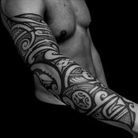 Polynesian style black ink sleeve tattoo of various ornaments
