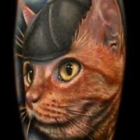 Portrait of a cat wearing a cap tattoo by Liz Cook