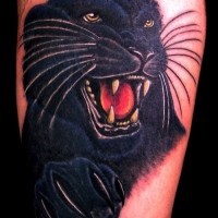 Portrait of a panther tattoo on leg