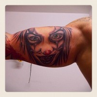 Portrait of a woman clown tattoo on arm