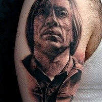 Portrait style black and white shoulder tattoo of man face