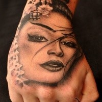 Portrait style black ink hand tattoo of Japanese geisha