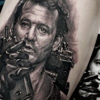 Portrait style black ink leg tattoo of famous actor face