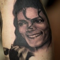 Portrait style black ink leg tattoo of Michael Jackson