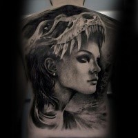 Portrait style black ink whole back tattoo of woman face with dinosaur skull