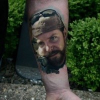 Portrait style colored arm tattoo of American sniper