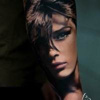 Portrait style colored arm tattoo of beautiful woman