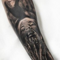 Portrait style colored arm tattoo of monster woman face