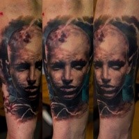Portrait style colored arm tattoo of human face