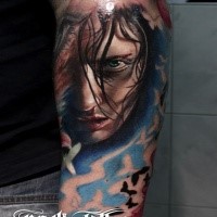 Portrait style colored arm tattoo of scary woman with butterflies