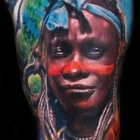 Portrait style colored arm tattoo of tribal human