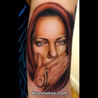 Portrait style colored arm tattoo of woman with hood