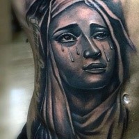 Portrait style colored belly tattoo of crying woman and lettering