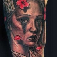 Portrait style colored biceps tattoo of Asian geisha