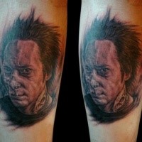 Portrait style colored creepy man face tattoo on leg