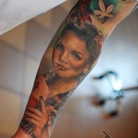 Portrait style colored forearm tattoo of sexy woman with cocktail