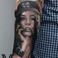 Portrait style colored forearm tattoo of seductive woman with hat