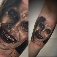 Portrait style colored forearm tattoo of creepy monster face
