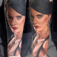 Portrait style colored forearm tattoo of beautiful woman face