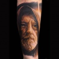 Portrait style colored forearm tattoo of Obi-wan Kenobi