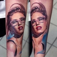 Portrait style colored forearm tattoo of beautiful woman in pink glasses