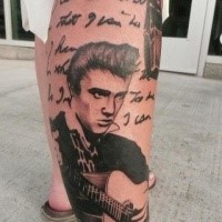 Portrait style colored leg tattoo of Elvis with guitar and lettering