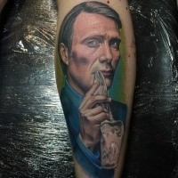Portrait style colored leg tattoo of famous actor