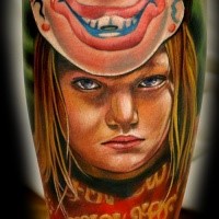 Portrait style colored leg tattoo of girls portrait with clown mask