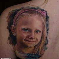 Portrait style colored scapular tattoo of cute girl face