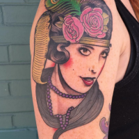 Portrait style colored shoulder tattoo of vintage portrait with flowers